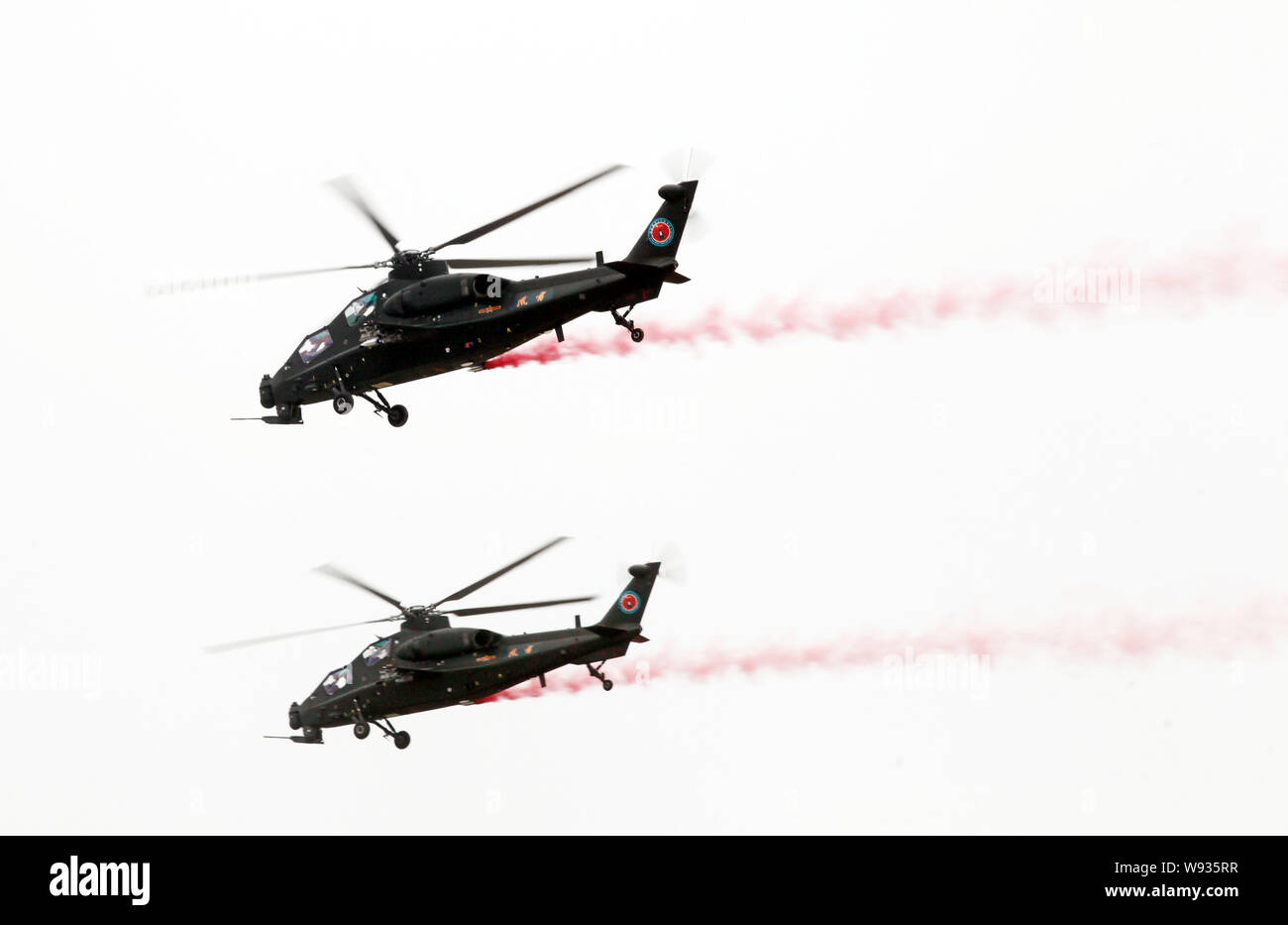 Chinese WZ-10 attack helicopters perform a flight demonstration at the 2nd China Helicopter Exposition in Tianjin, China, 5 September 2013.   The 2nd Stock Photo