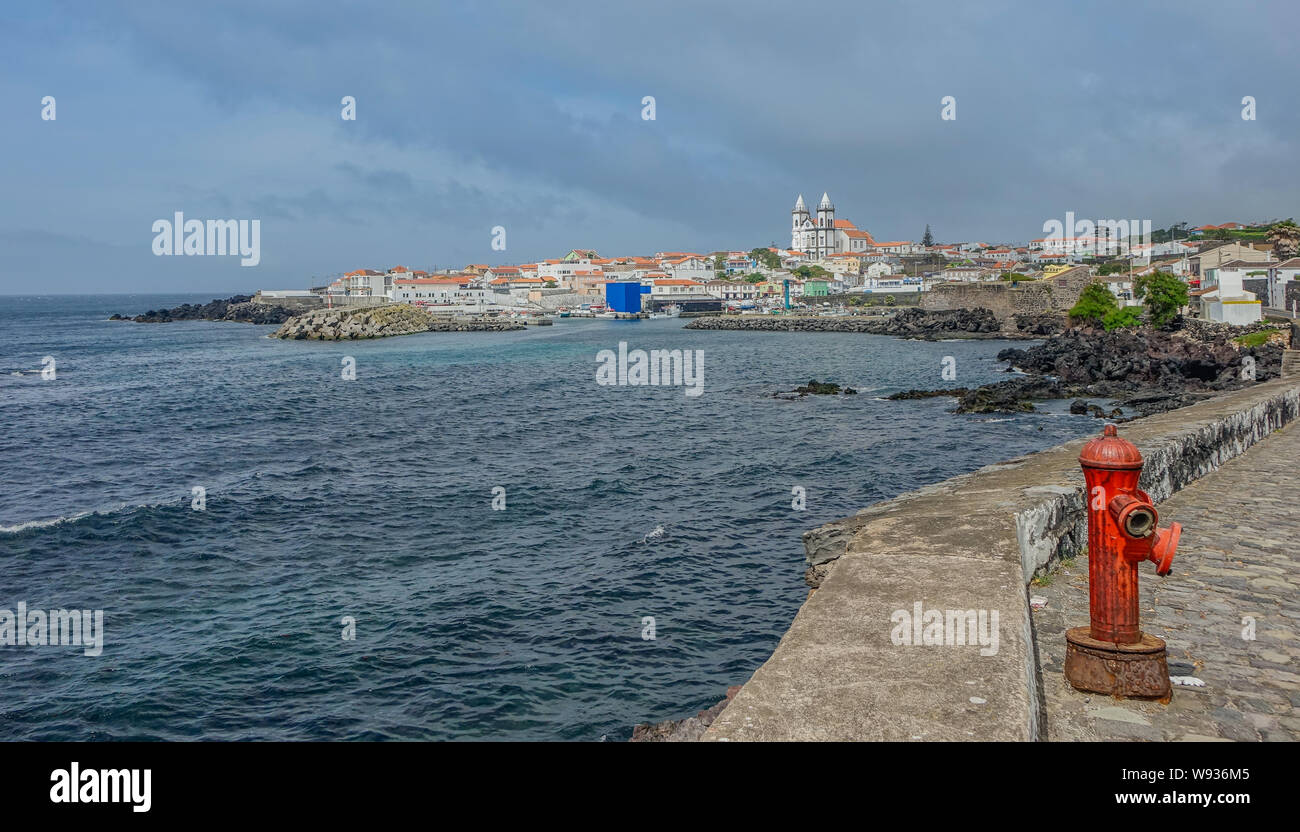 San Miguel, Terceira island, archipelago of the Azores, Portugal - May 6, 2016: View of church in a coastal village with the detail of a fire hydrant Stock Photo