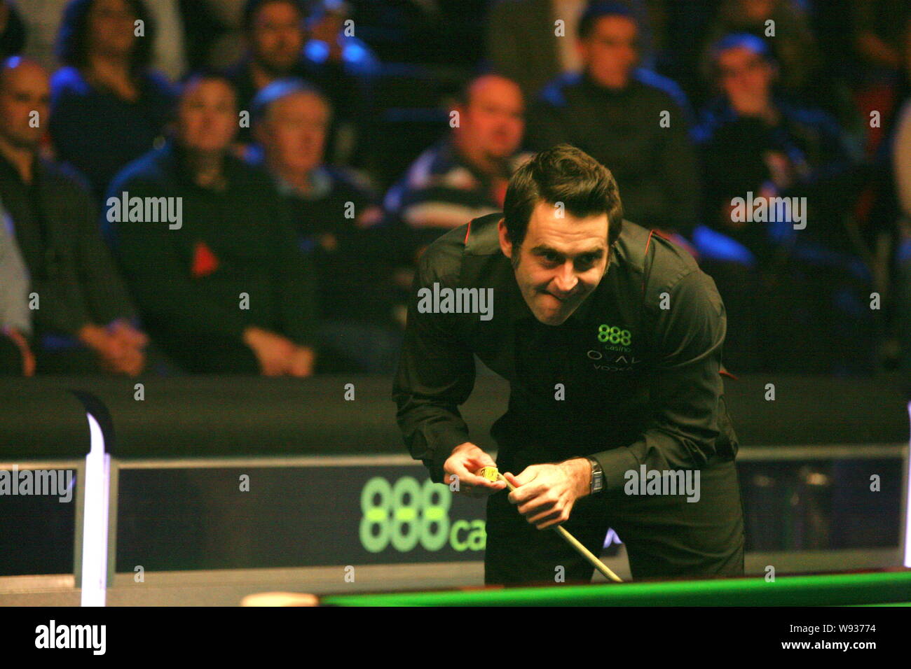 Ronnie OSullivan of England considers a shot against Stuart Bingham of England in the final of the 888casino Champion of Champions Snooker Tournament Stock Photo