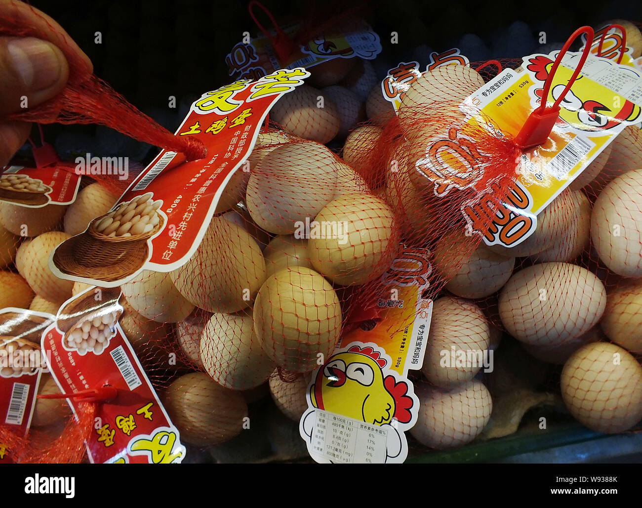 --FILE--A Chinese shopper buys eggs in a supermarket in Yichang city, central Chinas Hubei province, 6 March 2013.   Chinas annual inflation jumped to Stock Photo
