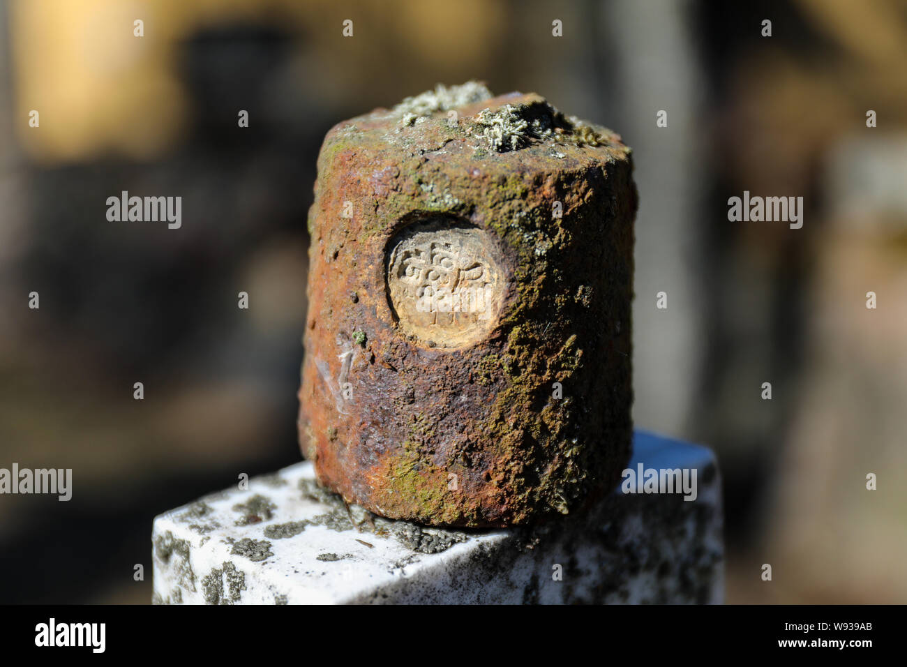 Rusty old 1 kg weight with stamp '1938' Stock Photo