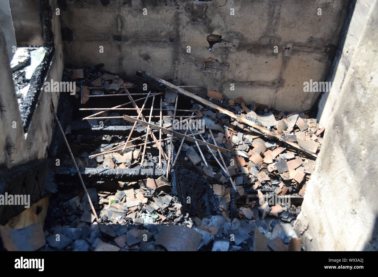 The burned-out house is pictured after a fire killed 7 people at a residential building in Ruian city, east Chinas Zhejiang province, 8 August 2013. Stock Photo
