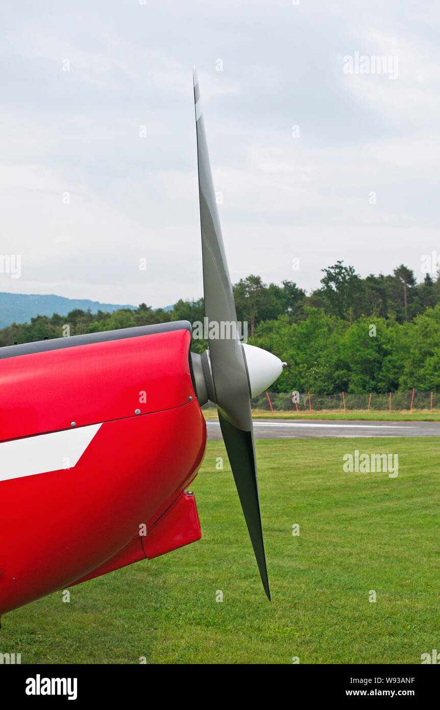 Side view of a the propeller of a light aircraft parked on grass Stock