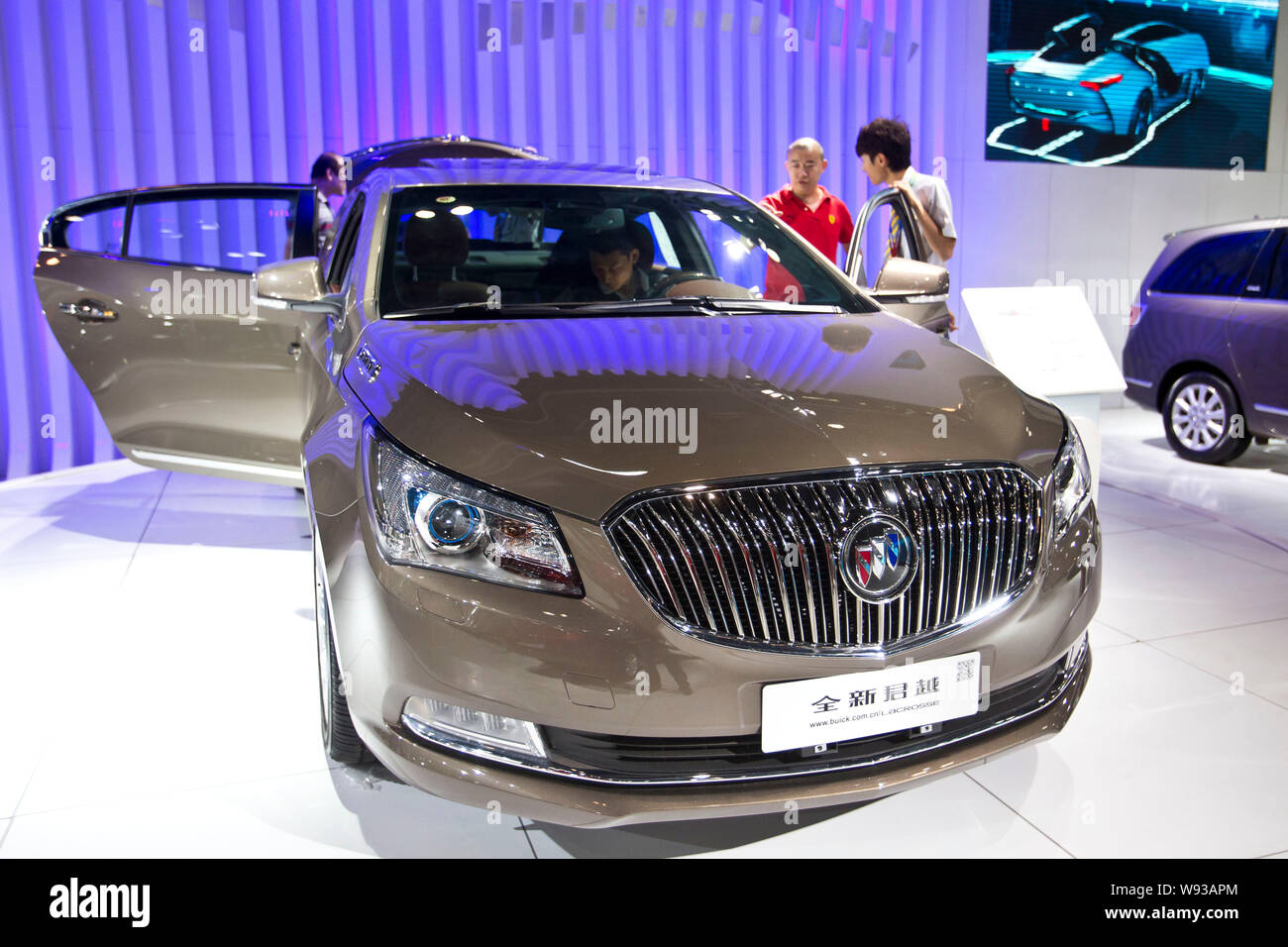 --FILE--Visitors look at a Buick car during an automobile exhibition in Beijing, China, 9 August 2013.   Chinas auto sales accelerated in August as an Stock Photo