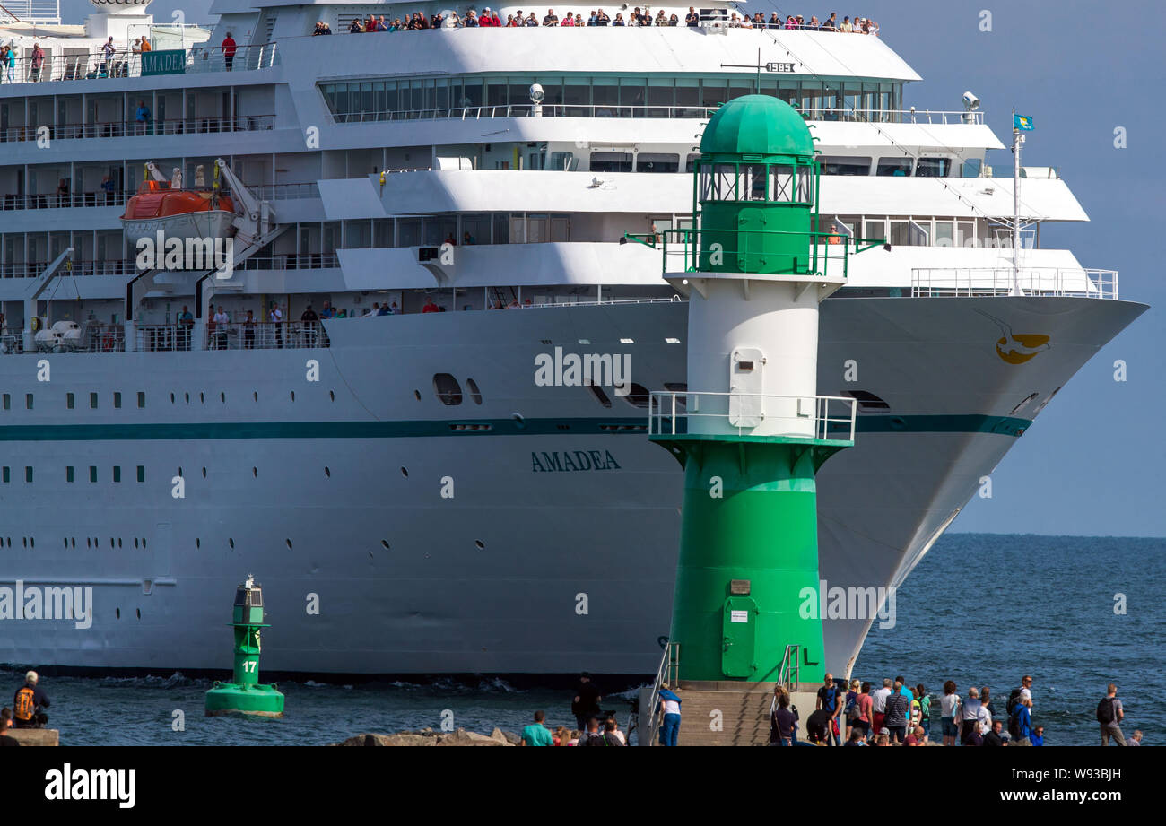 09 August 2019, Mecklenburg-Western Pomerania, Rostock-Warnemünde: The cruise ship 'Amadea' of the shipping company 'Phoenix Kreuzfahrten' enters the port of Rostock through the sea channel. On the second day of the 29th Hanse Sail, traditional and museum ships start their trips on the Baltic Sea. Until 11.08.2019, 170 ships and around one million visitors are expected to attend the four-day maritime fair. Photo: Jens Büttner/dpa-Zentralbild/ZB Stock Photo
