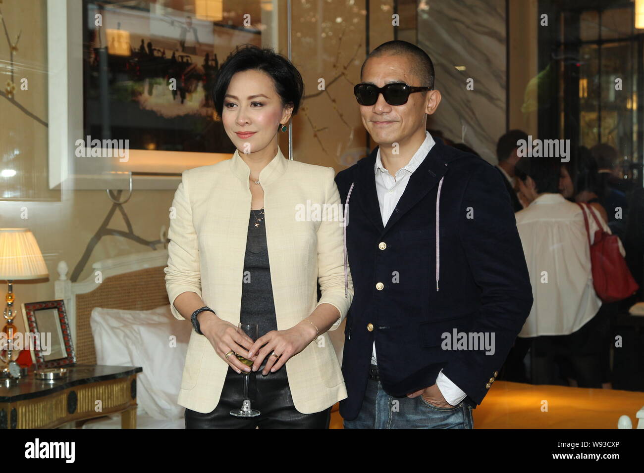 Hong Kong actress Carina Lau, left, and her actor husband Tony leung chiu wai pose during an opening ceremony for Hong Kong entrepreneur Sir David Tan Stock Photo