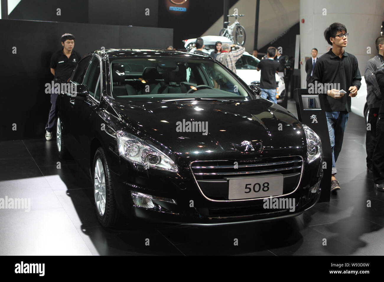 --FILE--A visitor walks past a Dongfeng Peugeot 508 during the 11th China (Guangzhou) International Automobile Exhibition, known as Auto Guangzhou 201 Stock Photo