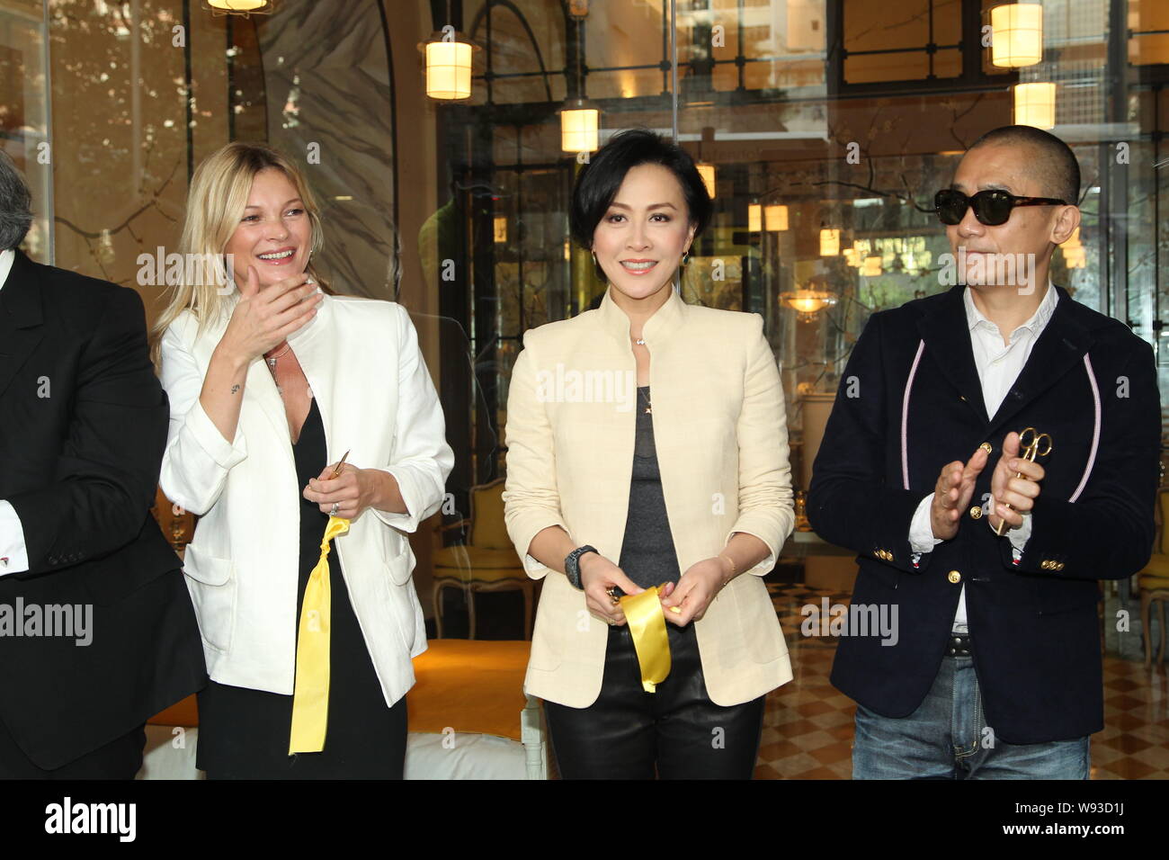 (From left) English supermodel Kate Moss, Hong Kong actress Carina Lau and her actor husband Tony leung chiu wai are pictured after cutting the ribbon Stock Photo