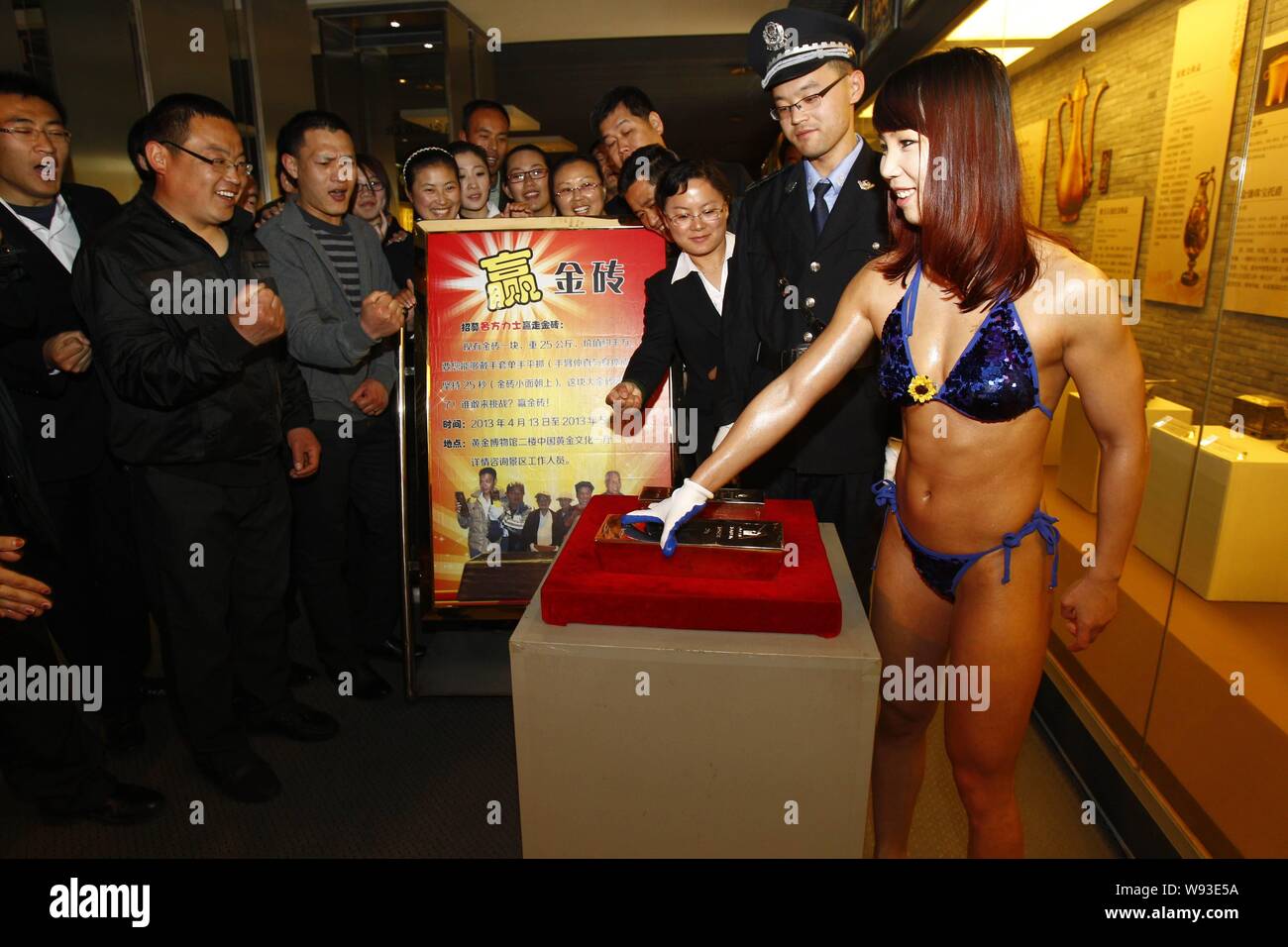 A young woman wearing a bikini prepares to snatch up a 25kg gold bullion  during a bullion lifting challenge at the China Gold Mining Museum in  Zhaoyua Stock Photo - Alamy