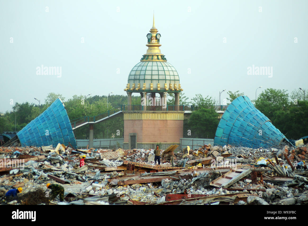 Chinese workers demolish the ruins of some fairytale castles at the Beijing Wonderland Amusement Park in Beijing, China, 12 May 2013.   Construction o Stock Photo