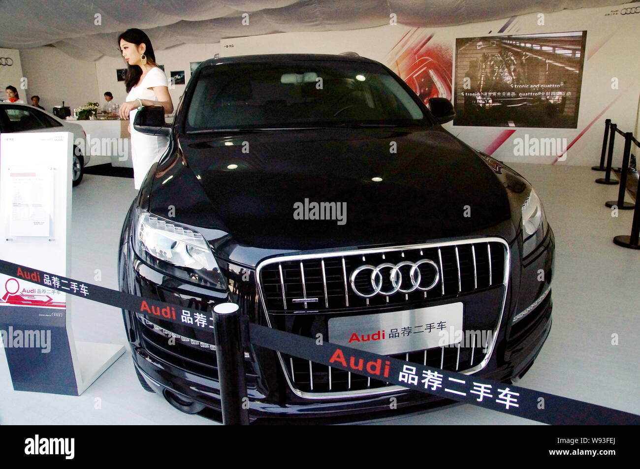 --FILE--A model poses with a pre-owned imported Audi Q7 during an auto show in Tianjin, China, 30 April 2013.   Chinas anti-trust regulators have been Stock Photo