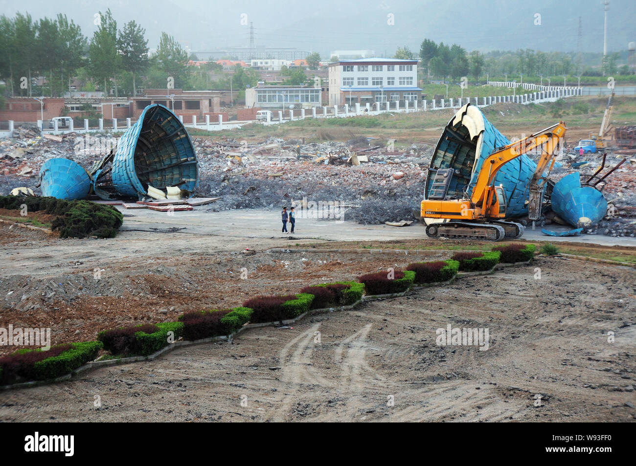 Chinese workers demolish the ruins of some fairytale castles at the Beijing Wonderland Amusement Park in Beijing, China, 12 May 2013.   Construction o Stock Photo