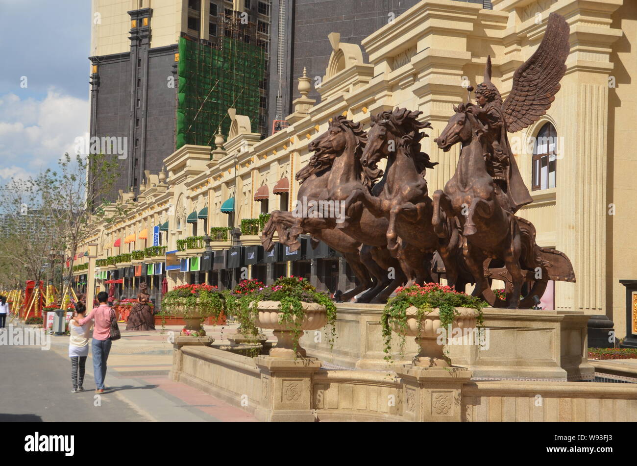 Pedestrians walk on a fake luxury shopping strip in Shenyang, northeast Chinas Liaoning province, 1 September 2013.   China is known to the world for Stock Photo