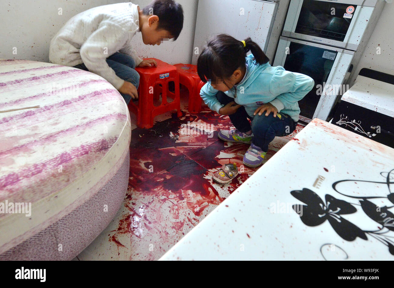 Two Young Students Look At The Bloody Floor At The Home Of Their