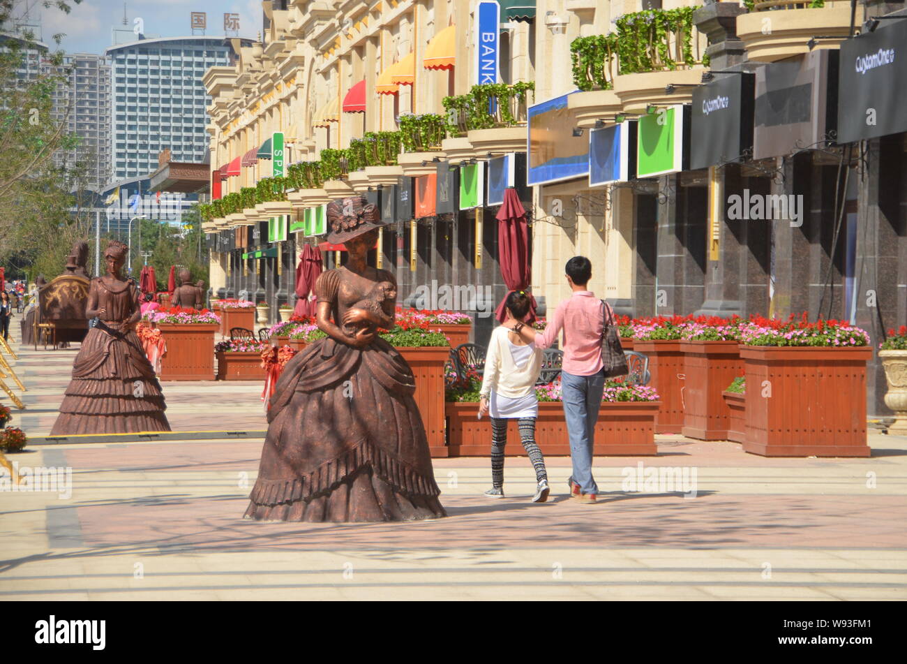 Pedestrians walk on a fake luxury shopping strip in Shenyang, northeast Chinas Liaoning province, 1 September 2013.   China is known to the world for Stock Photo