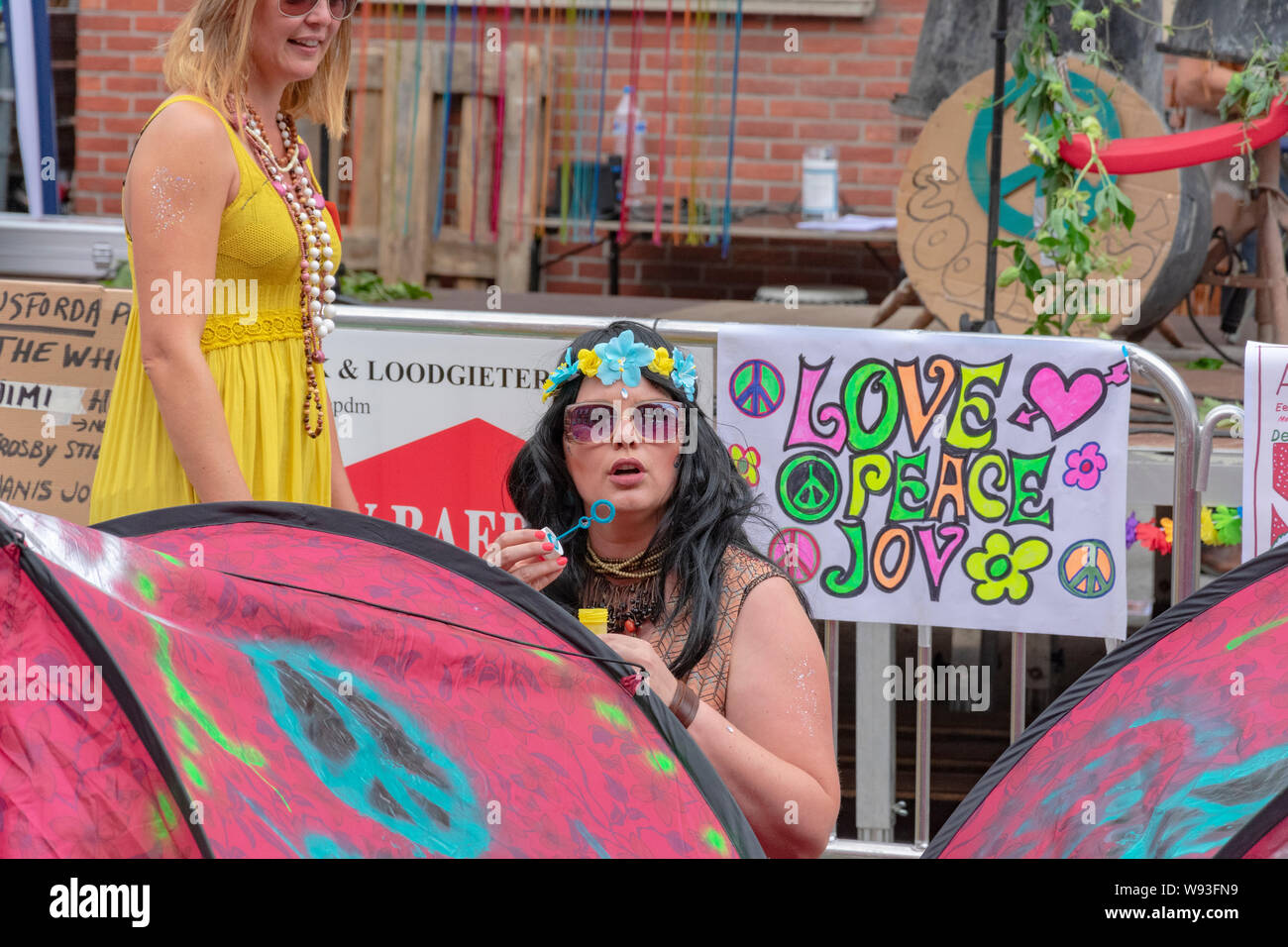 Sint Gillis Waas, Belgium, August 3, 2019, Remember Woodstock festival, love, peace and understanding. Girl is blowing soap bubbles at the festival Stock Photo