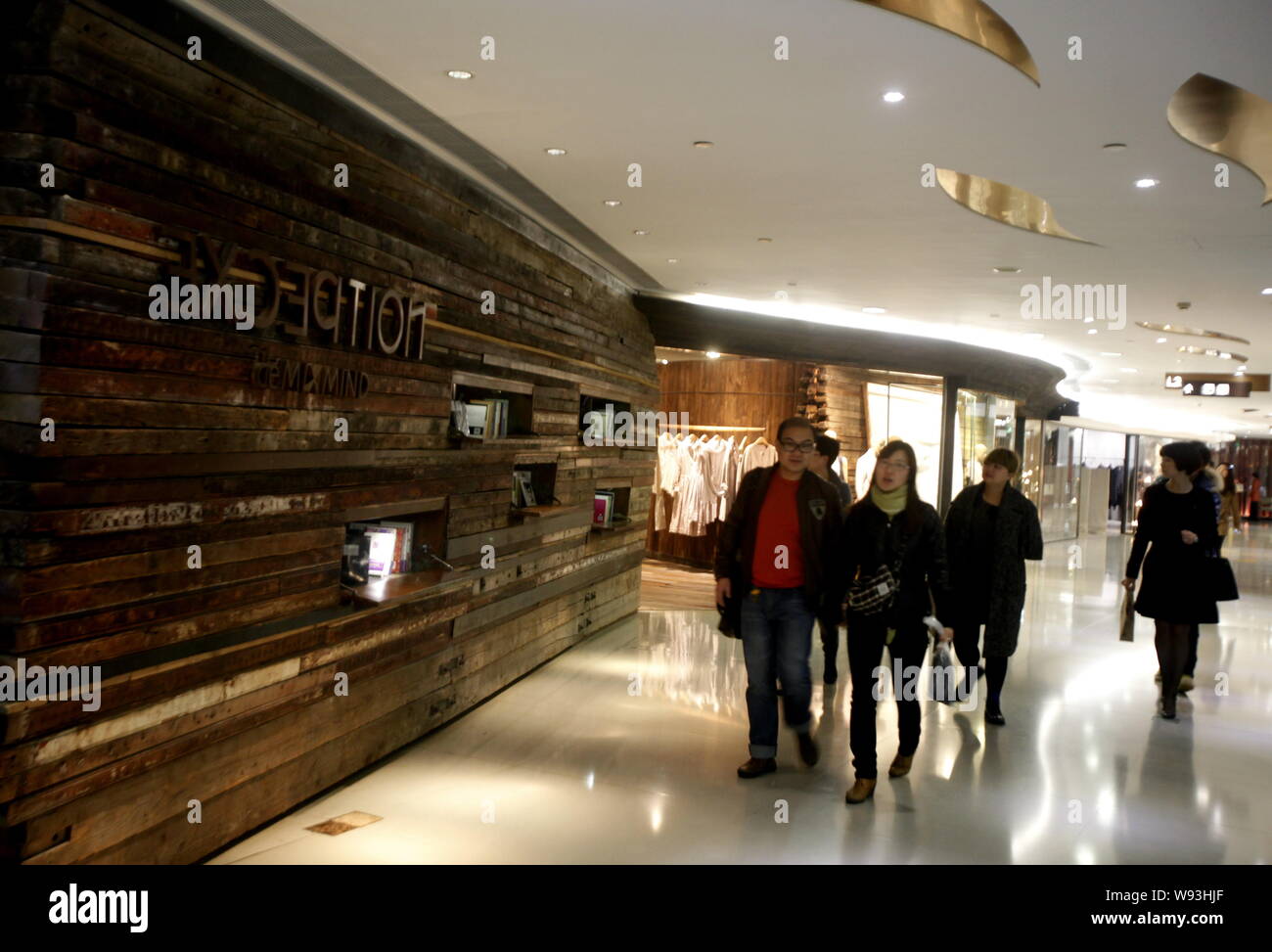 FILE--Customers walk past a boutique of Louis Vuitton (LV) in Shanghai,  China, 3 October 2017. Global luxury brands from Prada to LVMH are invest  Stock Photo - Alamy
