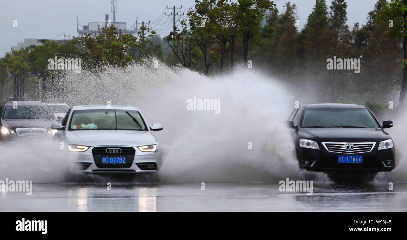 Cars travel on a flooded road after heavy rain caused by Typhoon Trami in Ruian, Wenzhou city, east Chinas Zhejiang province, 22 August 2013.   Southe Stock Photo