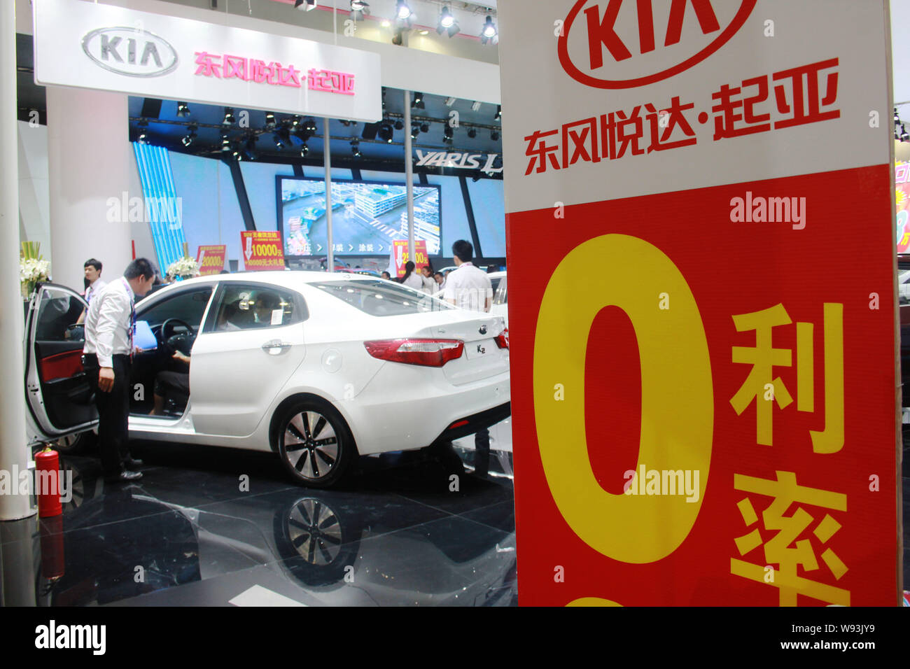 Visitors try out a Kia car during an automobile exhibition in Haikou, south Chinas Hainan province, 7 September 2013.   Chinas auto sales accelerated Stock Photo
