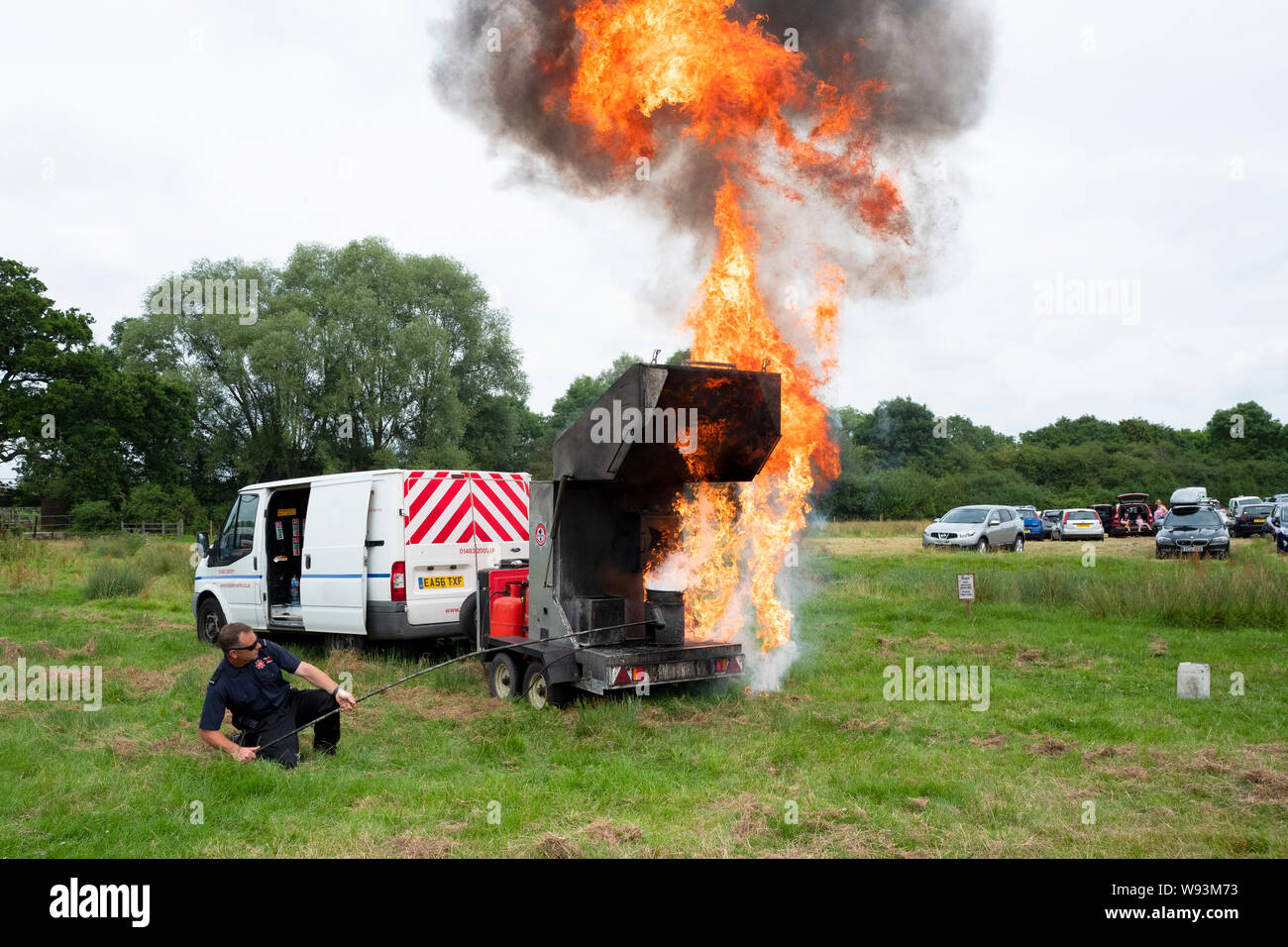 Fire Brigade demonstration as to the effects of pouring water on a chip pan oil fire. Stock Photo