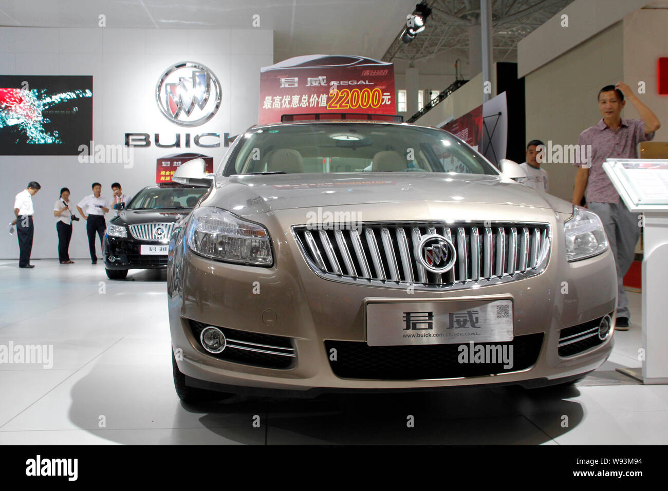 FILE--Visitors look at a Buick Regal of Shanghai GM, a joint venture  between SAIC and General Motors, during an auto show in Haikou city, south  Chi Stock Photo - Alamy