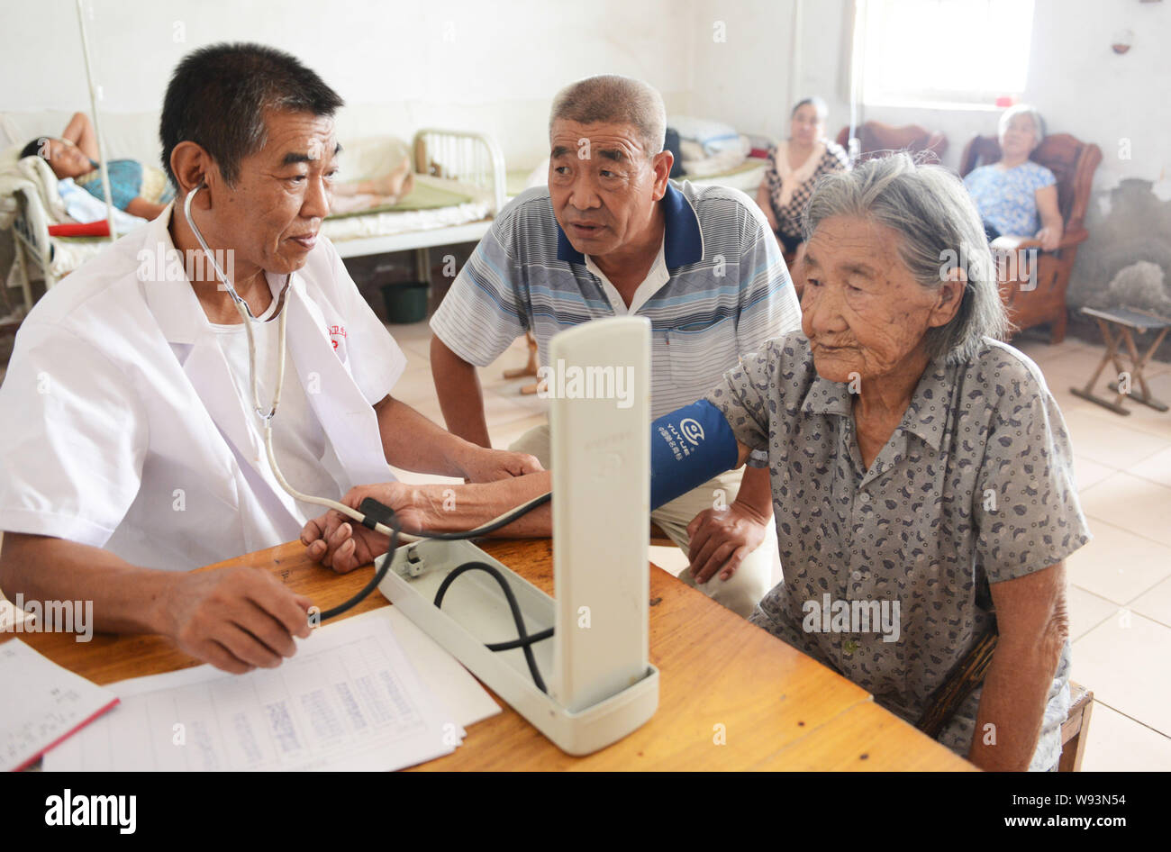 Local elderly people receive free physical examinations at a clinic in Zouping county, east Chinas Shandong province, 25 August 2013.   Filial piety i Stock Photo