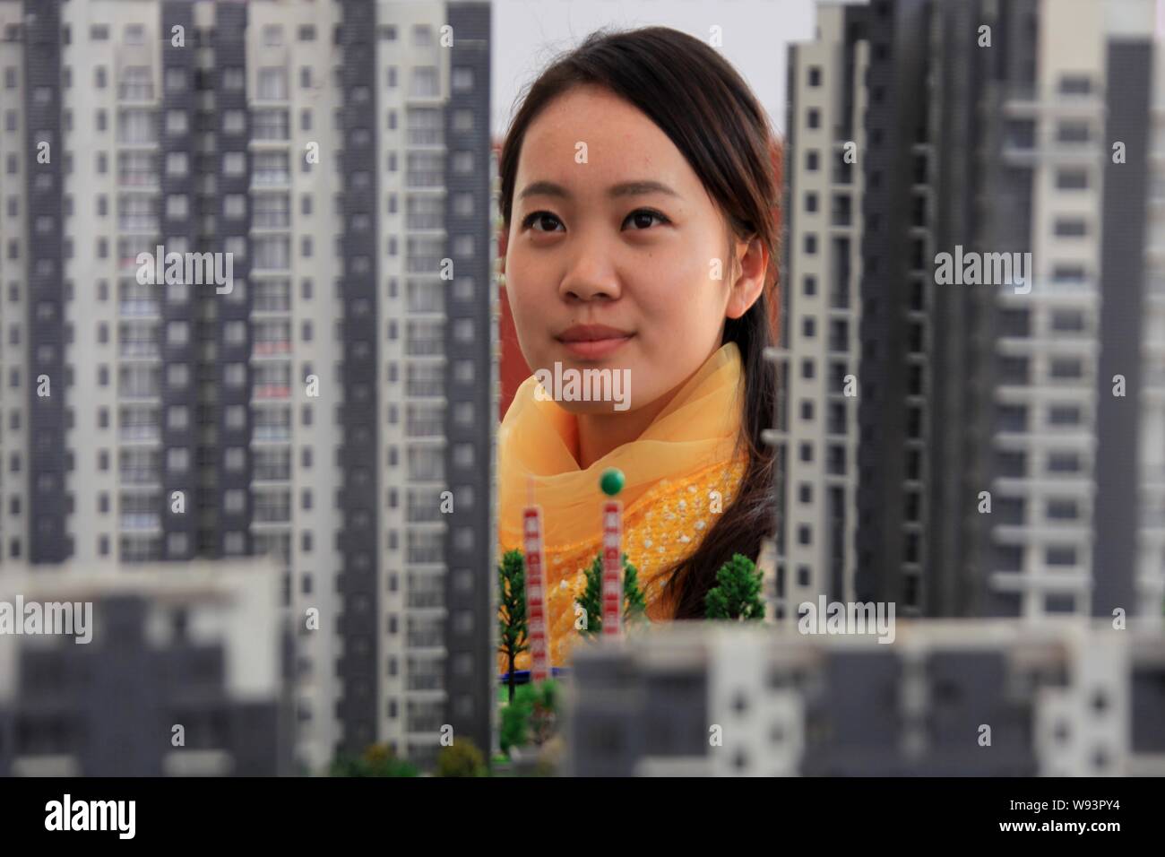 A Chinese homebuyer looks at models of residential apartment buildings during a real estate fair in Huangshan city, east Chinas Anhui province, 16 Nov Stock Photo