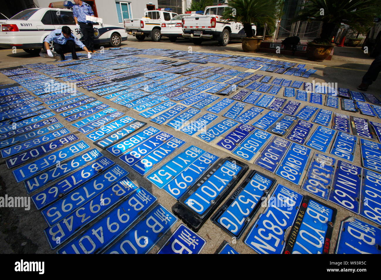 Chinese police officers check and register unclaimed car plates which were washed away by heavy rains caused by Typhoon Fitow at a branch of traffic p Stock Photo