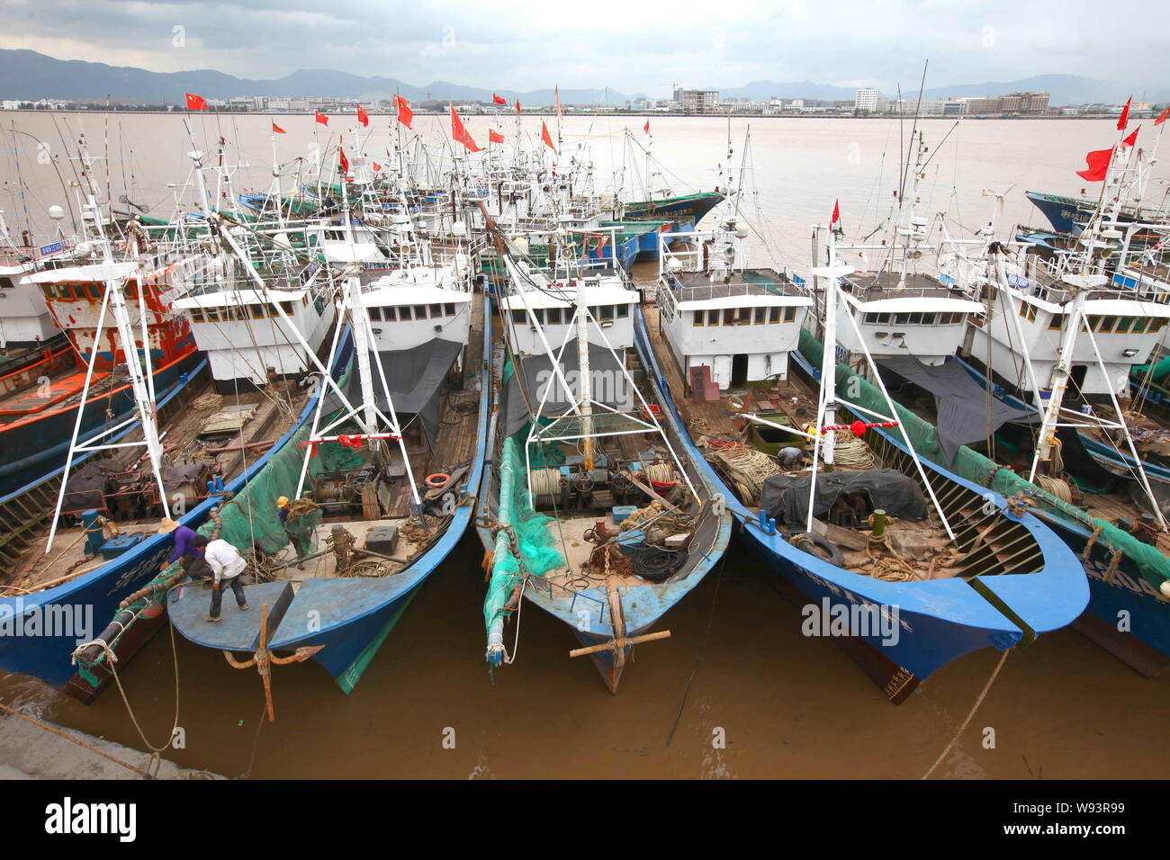 Fishing boats are docked at a harbor as Typhoon Trami approaches in Ruian city, east Chinas Zhejiang province, 21 August 2013.   China braced itself f Stock Photo