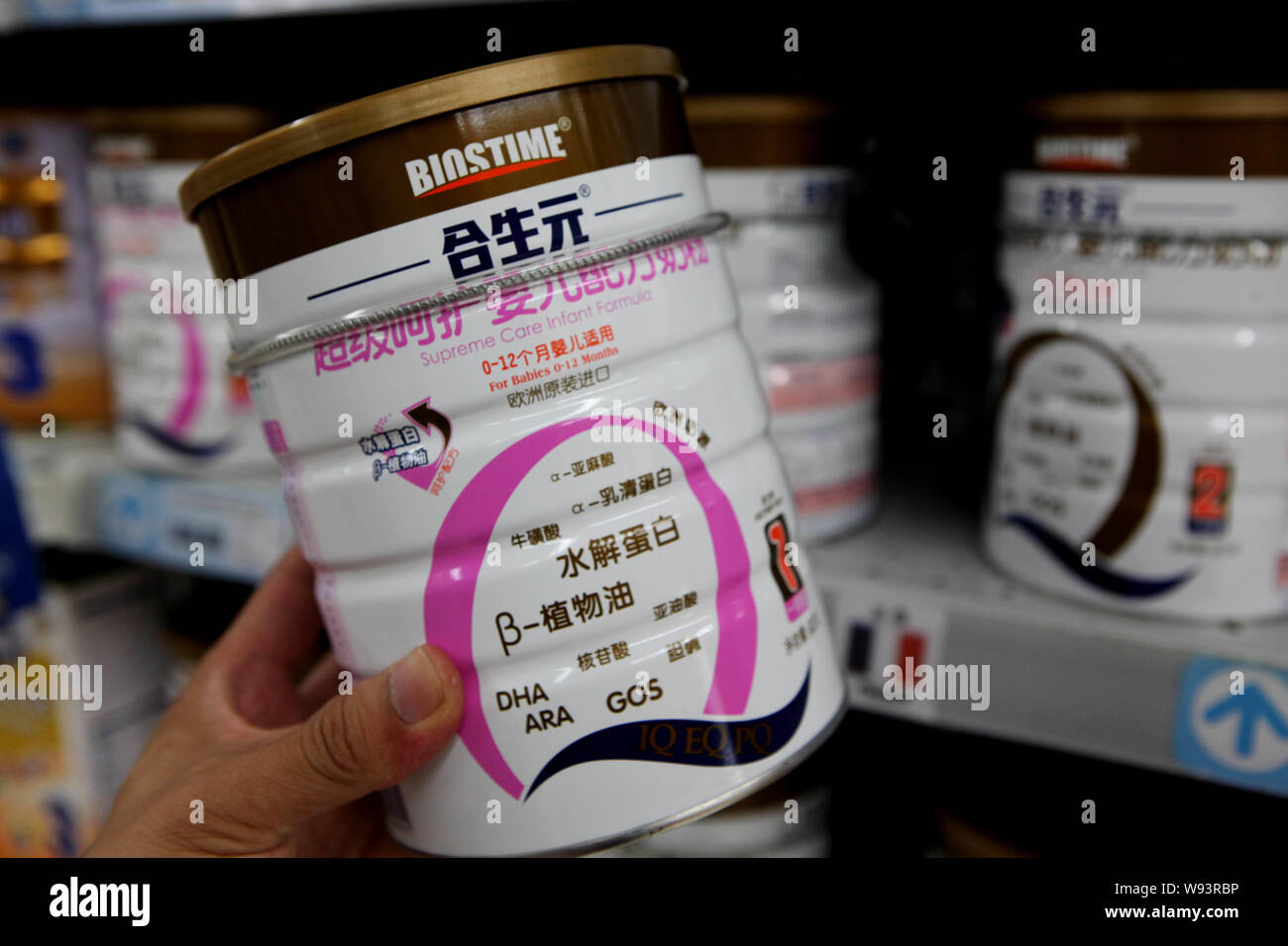 A customer buys a tin of Biostime supreme care infant formula at a