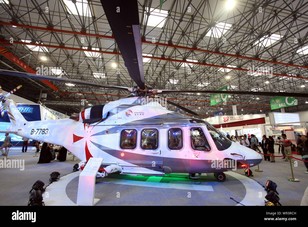Visitors look at an AgustaWestland AW139 medium sized twin-engined helicopter at the 2nd China Helicopter Exposition in Tianjin, China, 5 September 20 Stock Photo