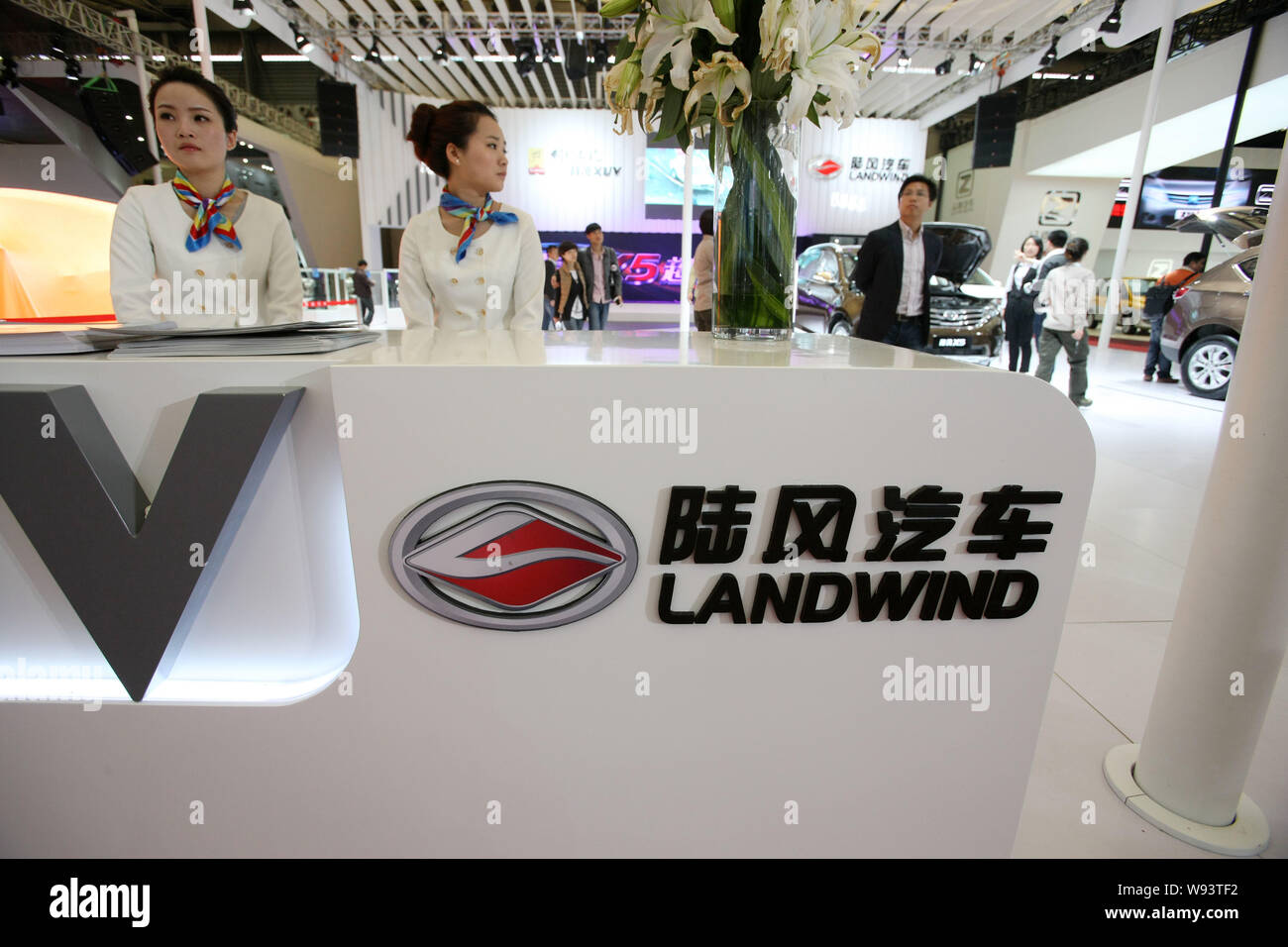 --FILE--Employees are seen at the stand of Landwind of Jiangling Motors during the 15th Shanghai International Automobile Industry Exhibition, known a Stock Photo