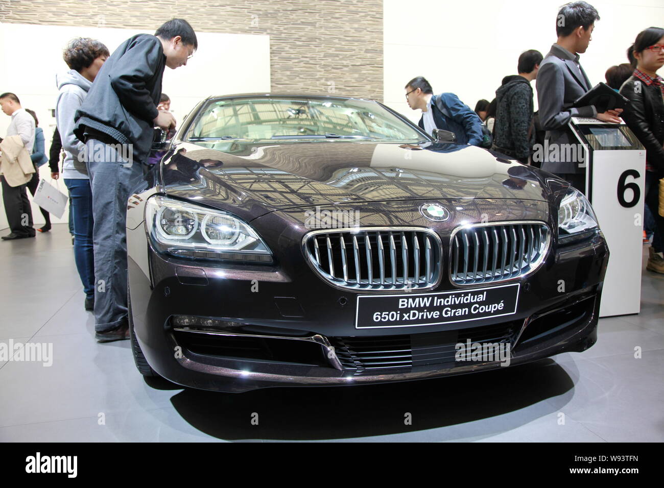 --FILE--Visitors look at an imported BMW Individual 650i xDrive Gran Coupe during the 15th Shanghai International Automobile Industry Exhibition, know Stock Photo