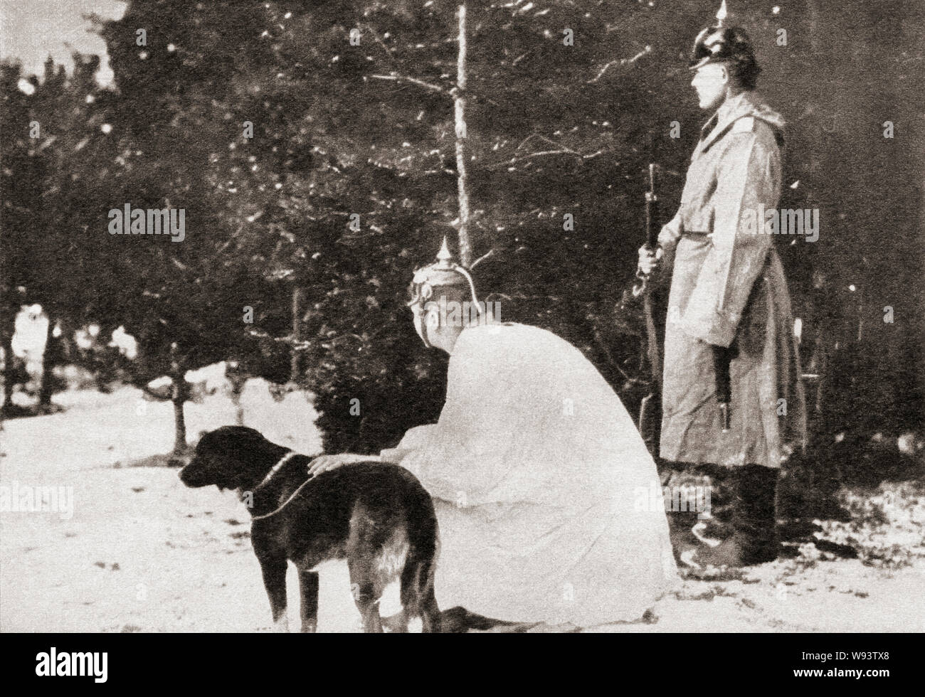 An early attempt at camouflage. A german soldier is seen here during WWI wearing a white cloak lest his dark uniform show up against the snow covered Polish landscape.  From The Pageant of the Century, published 1934. Stock Photo