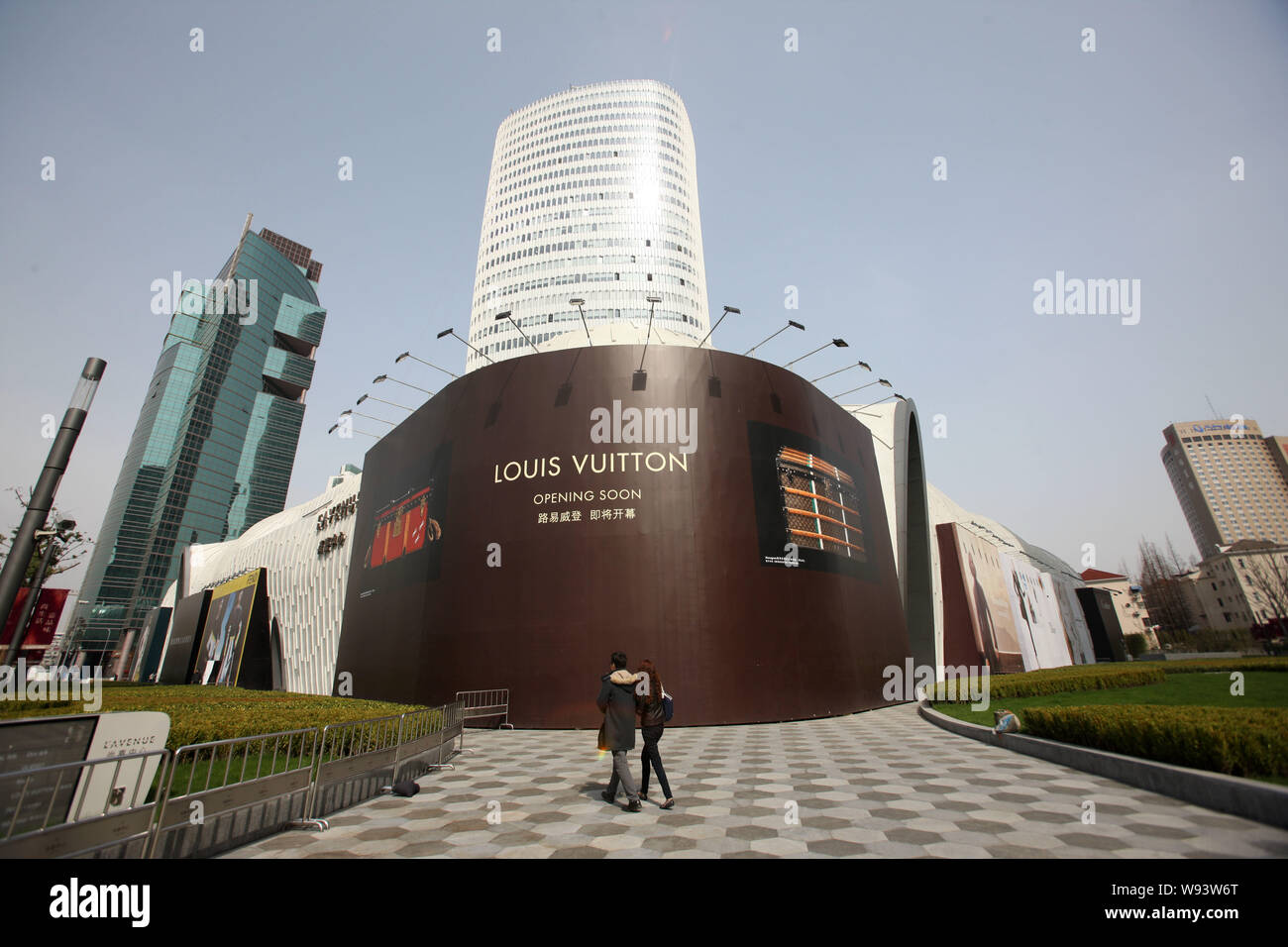 FILE--A pedestrian walks past a fashion boutique of Louis Vuitton (LV) at  the headquarters building of LVMH China, also known as the L'Avenue Shangh  Stock Photo - Alamy