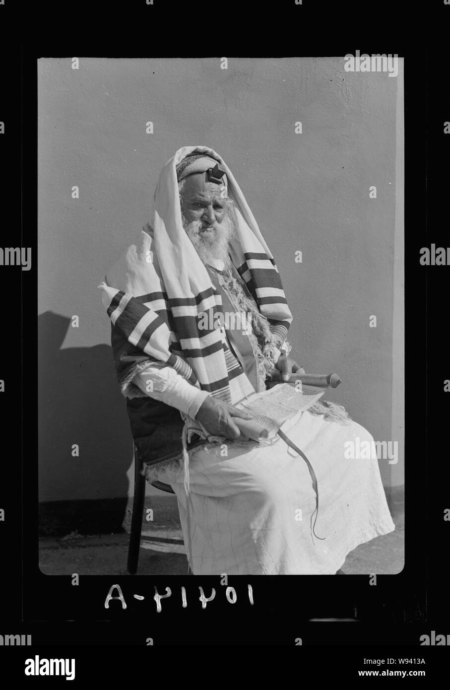 Abram Yemenite Jew with book in hand, reading scroll (Magella) with phylacteries on forehead Stock Photo