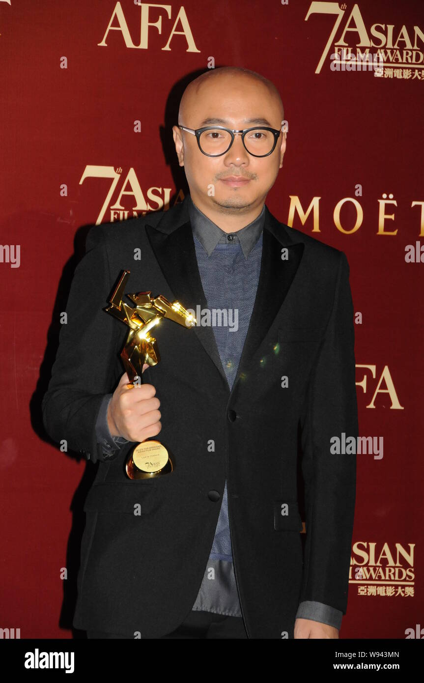Chinese actor and director Xu Zheng poses with his trophy after winning