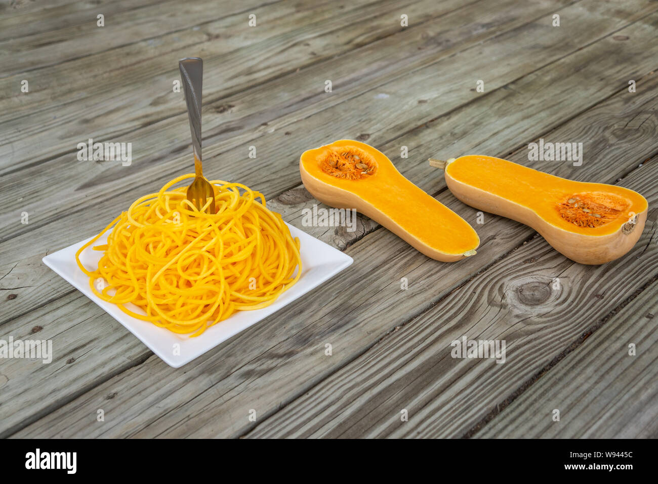Butternut squash noodles with fork stuck in the middle of the pasta