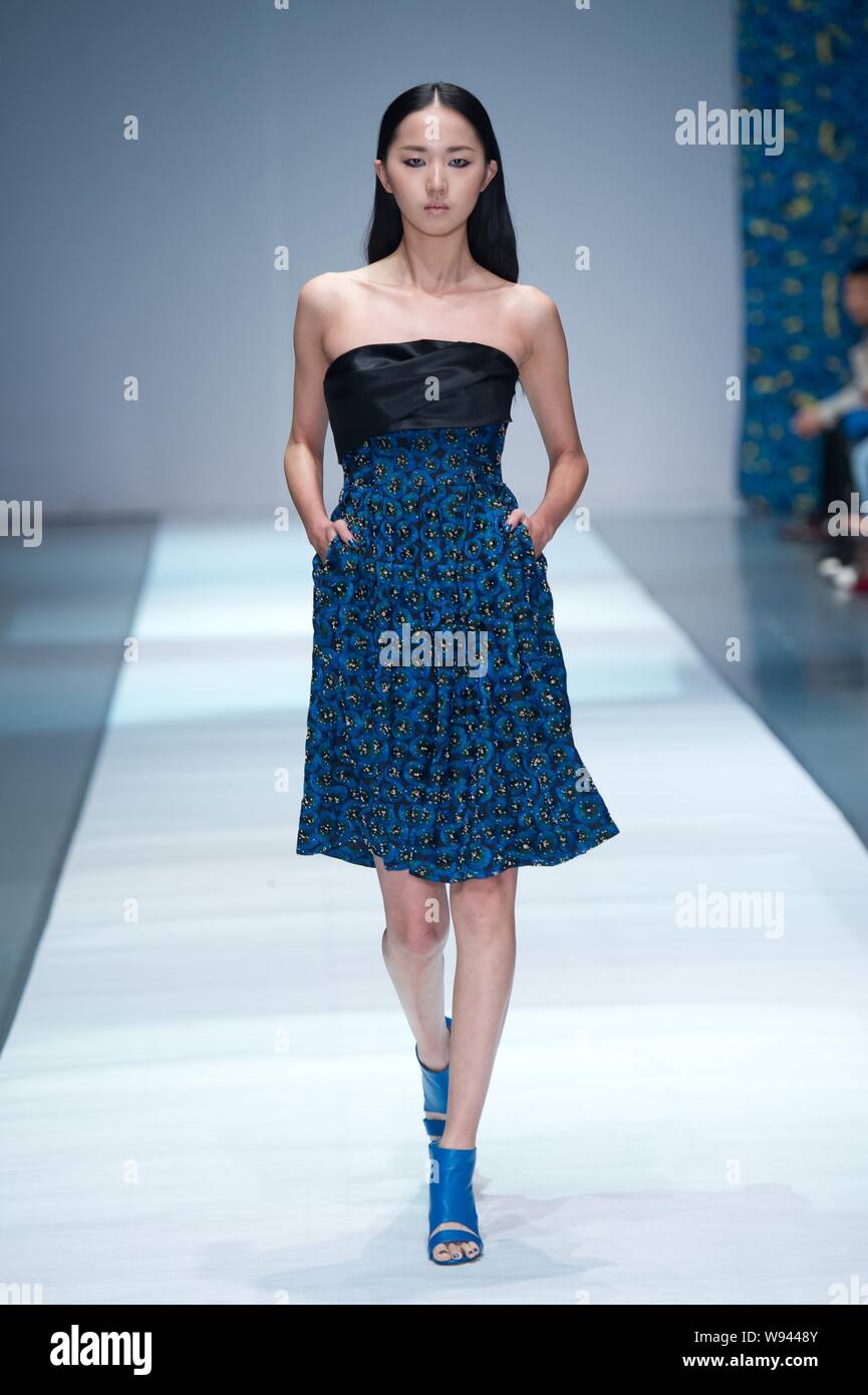A model displays a new creation by designer Wang Peiyi, at the Wang ...