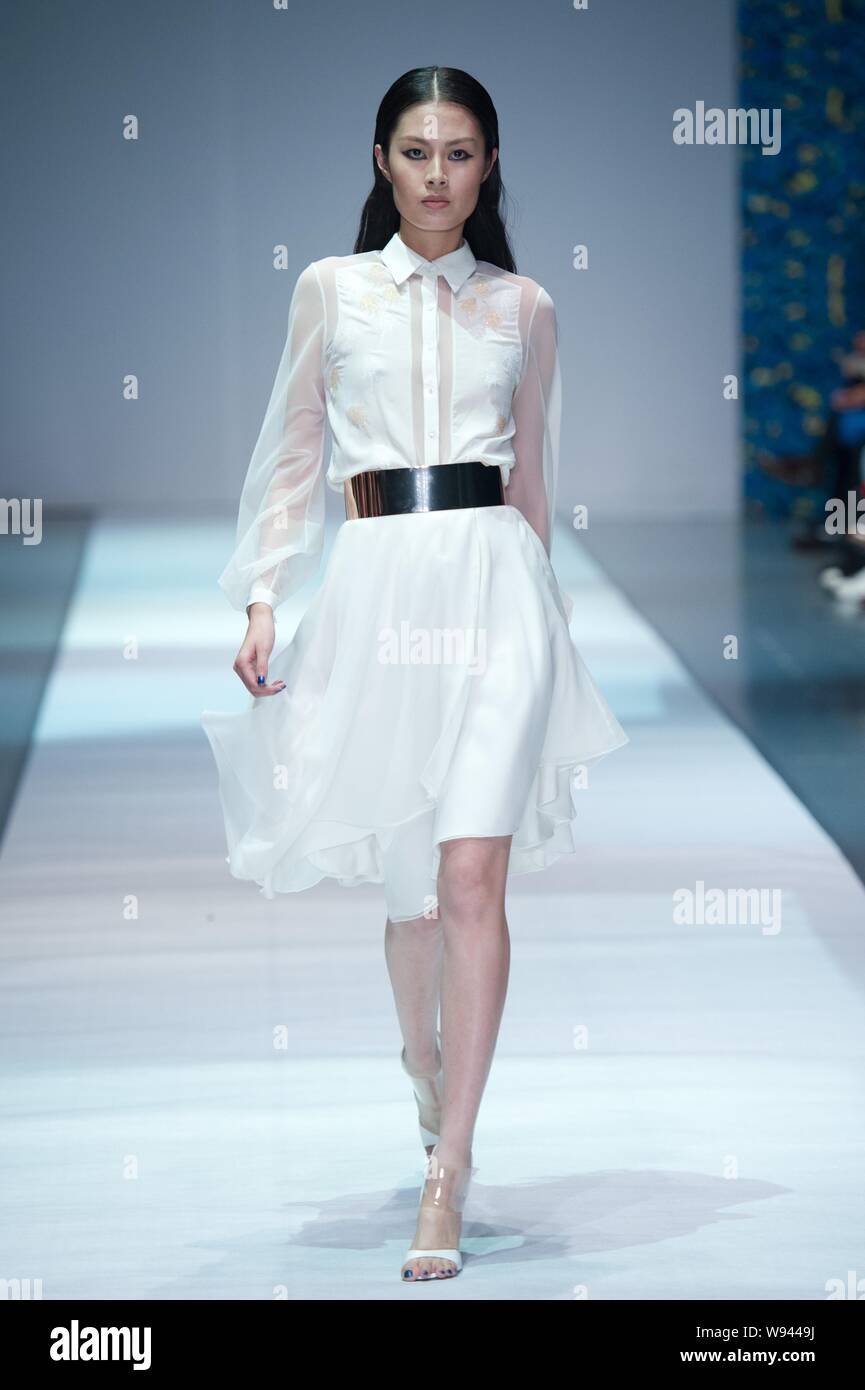 A model displays a new creation by designer Wang Peiyi, at the Wang ...