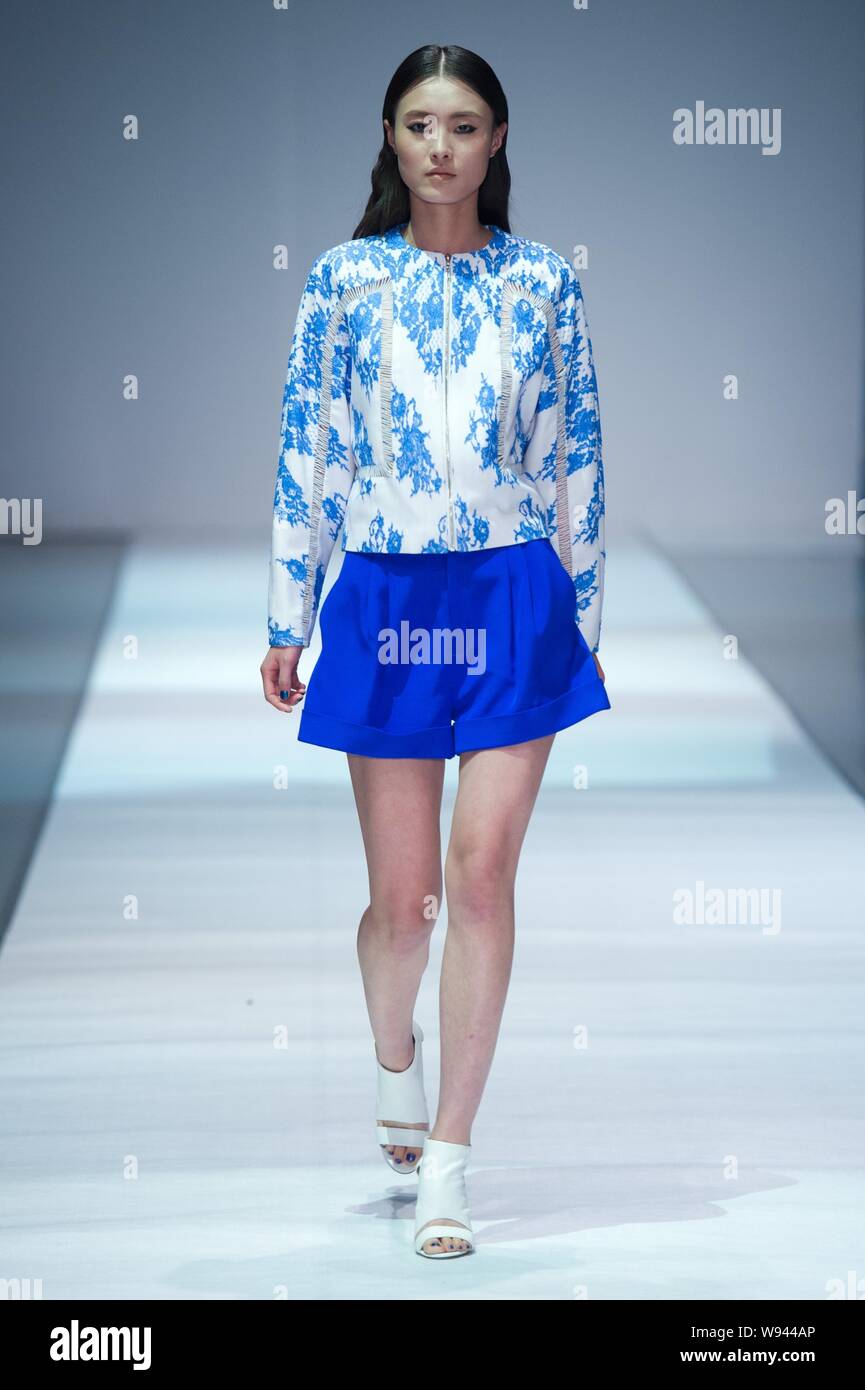 A model displays a new creation by designer Wang Peiyi, at the Wang ...