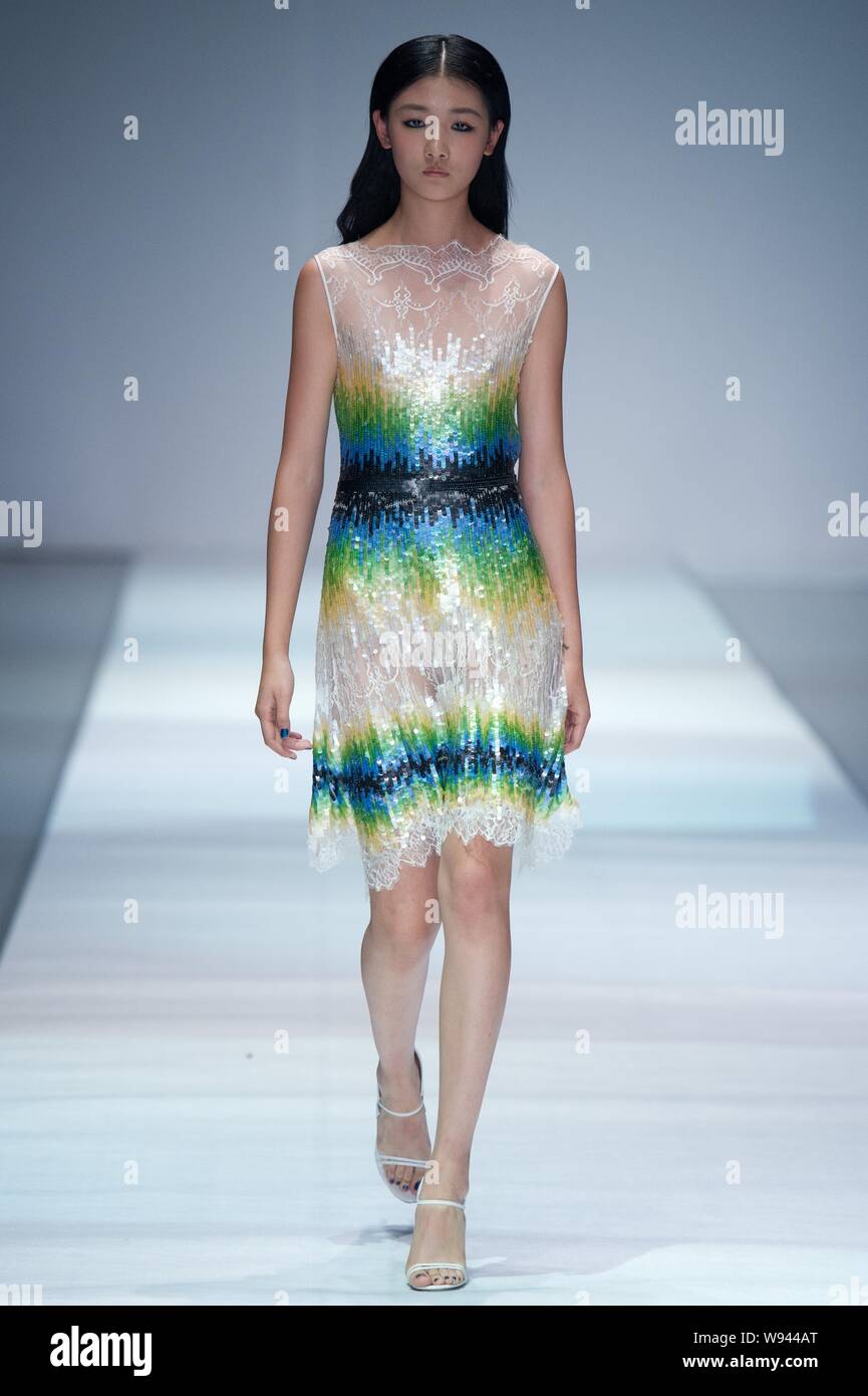A model displays a new creation by designer Wang Peiyi, at the Wang ...