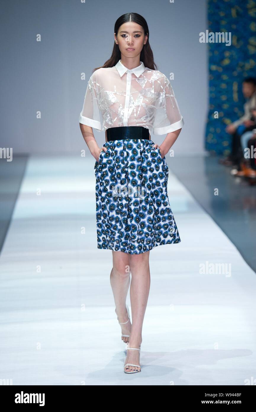 A model displays a new creation by designer Wang Peiyi, at the Wang ...