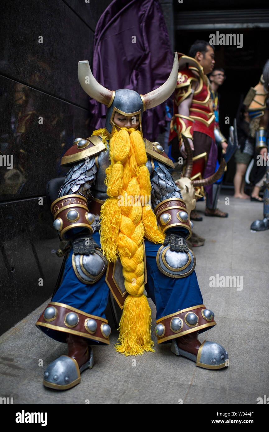 A Chinese contestant dressed in the costume of Mountain King from the online game World of Warcraft rests before a performance in the final of the 10t Stock Photo