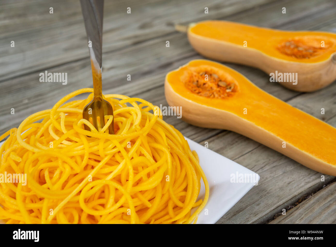 Butternut squash noodles with fork stuck in the middle of the pasta