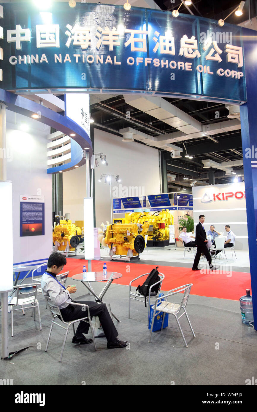 --FILE--An employee sits at the stand of China National Offshore Oil ...
