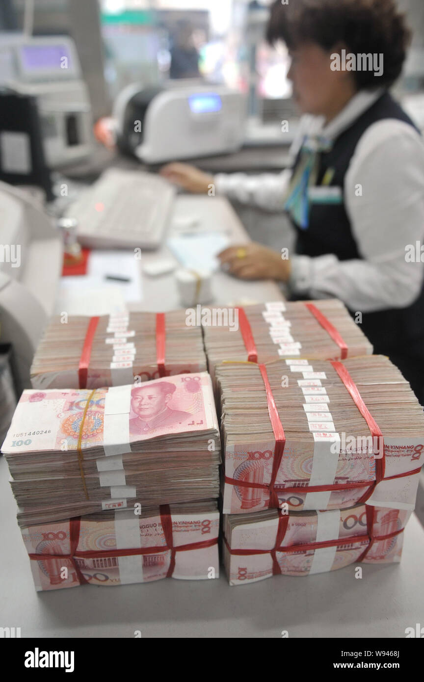 --FILE--A Chinese clerk counts RMB (renminbi) at a bank in Qionghai ...