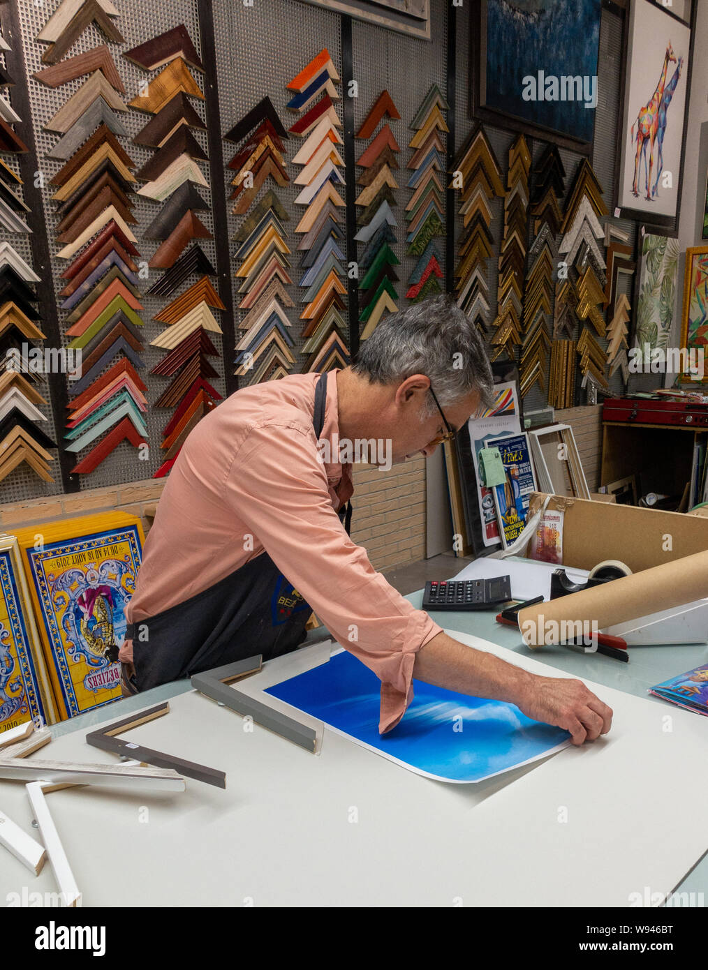 frame maker man measures picture for framing in a framing shop Stock Photo Alamy