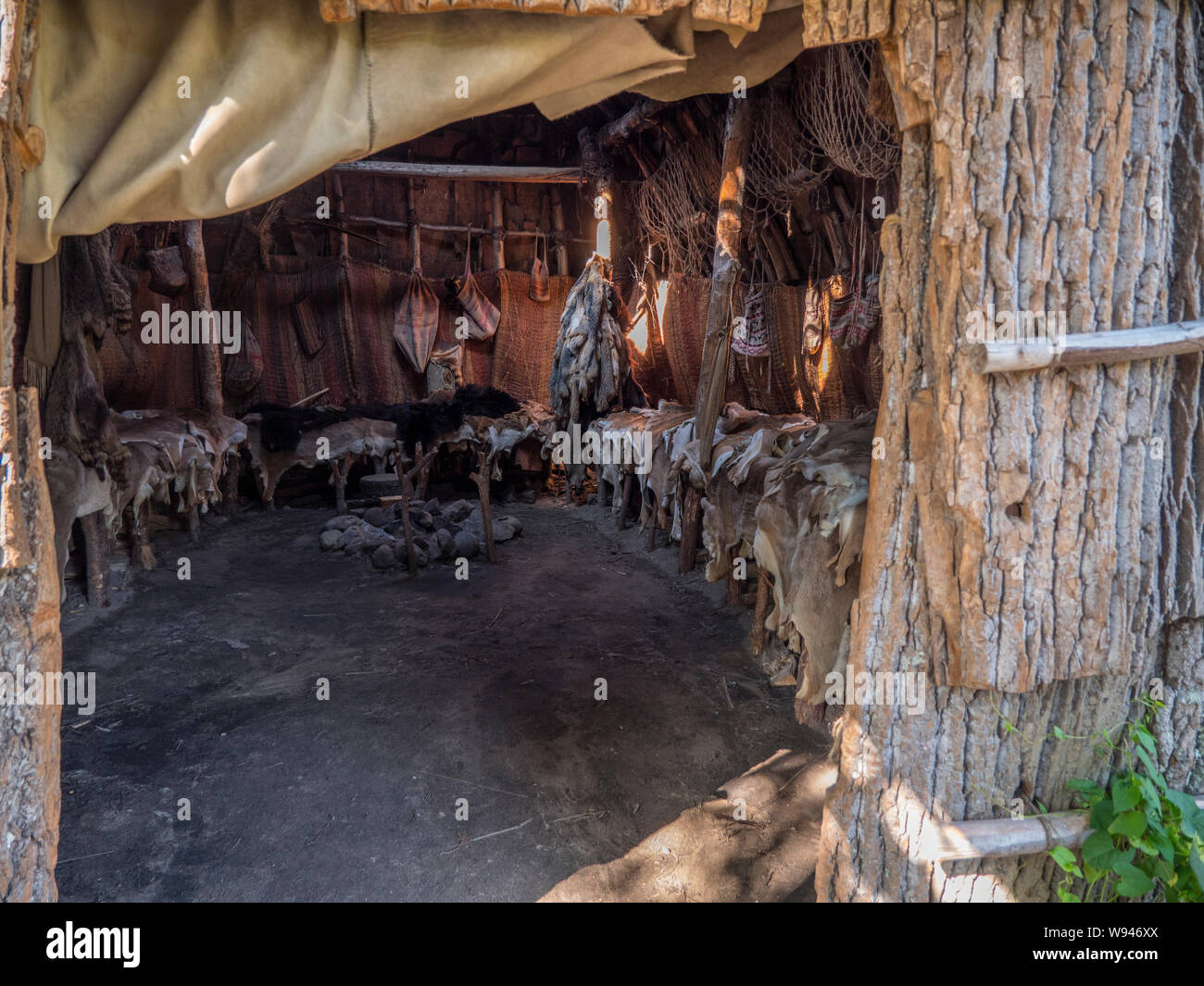 Inside Wampanoag home called a nush wetu containing animal skins. Stock Photo