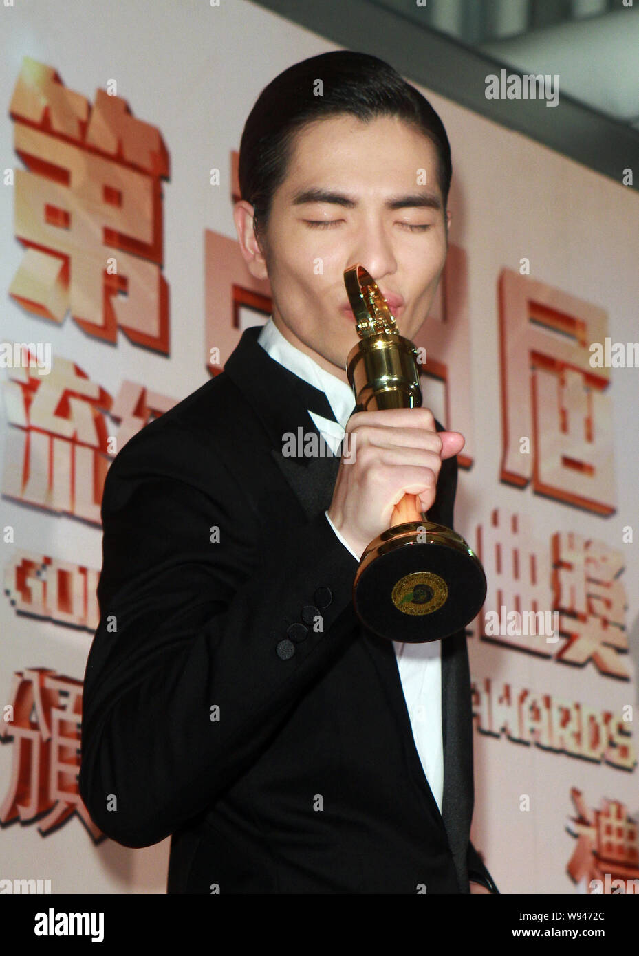 Taiwanese singer Jam Hsiao kisses his trophy after the award ceremony of the 24th Taiwan Golden